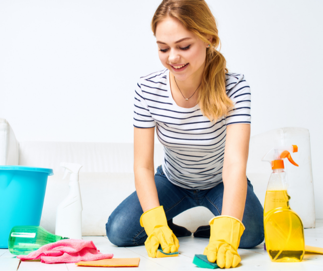 A woman brushing the floor